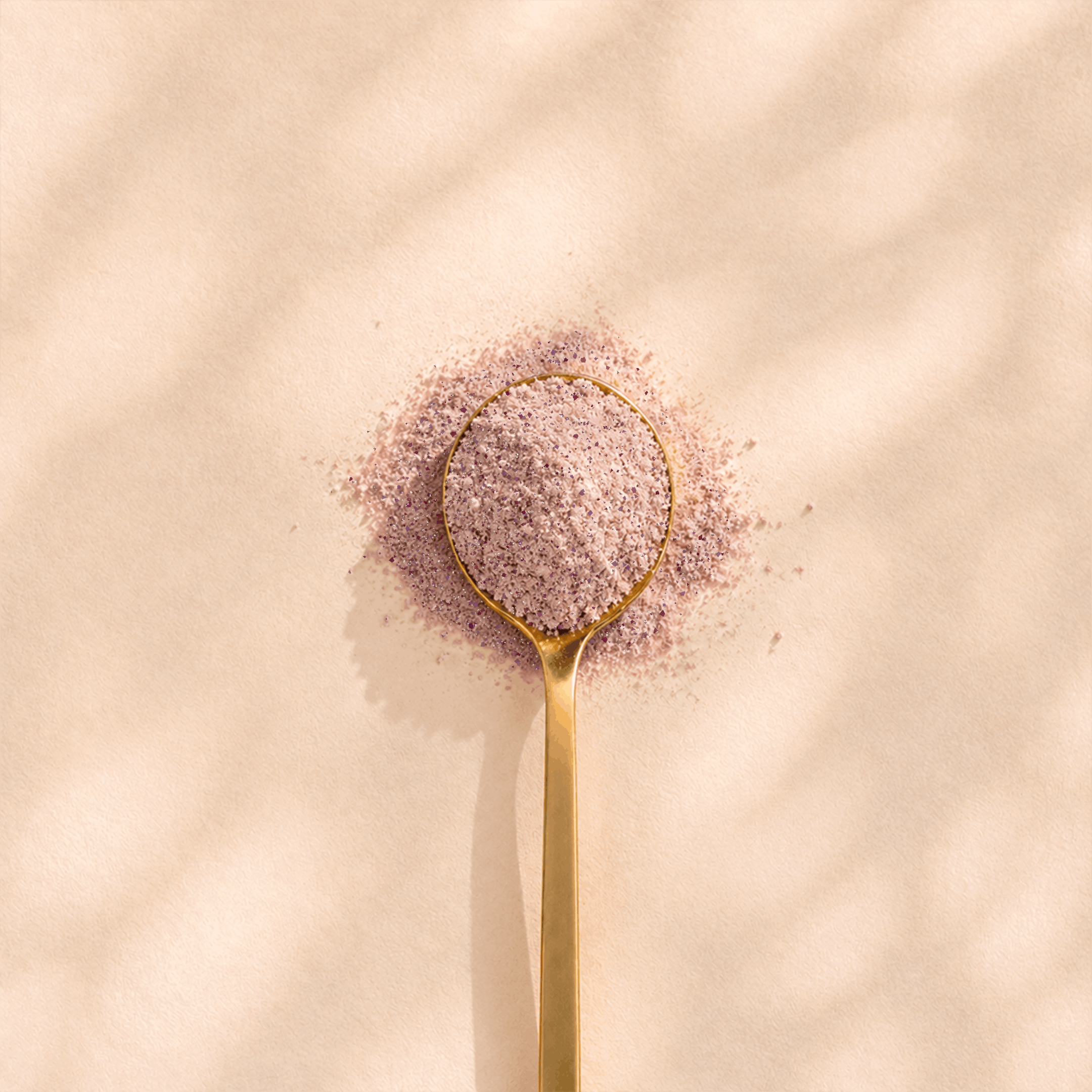 Spoonful of speckled pink Lumunom powder